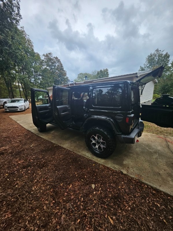 Silver sedan being pressure washed with soap foam