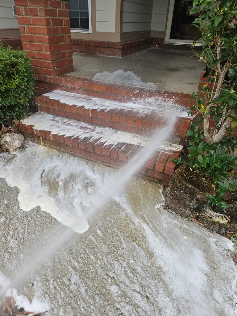 Brick steps and porch being foam washed